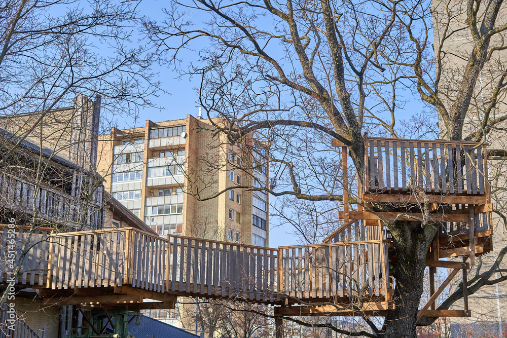 Small terrace and hanging pathway connecting two trees. 