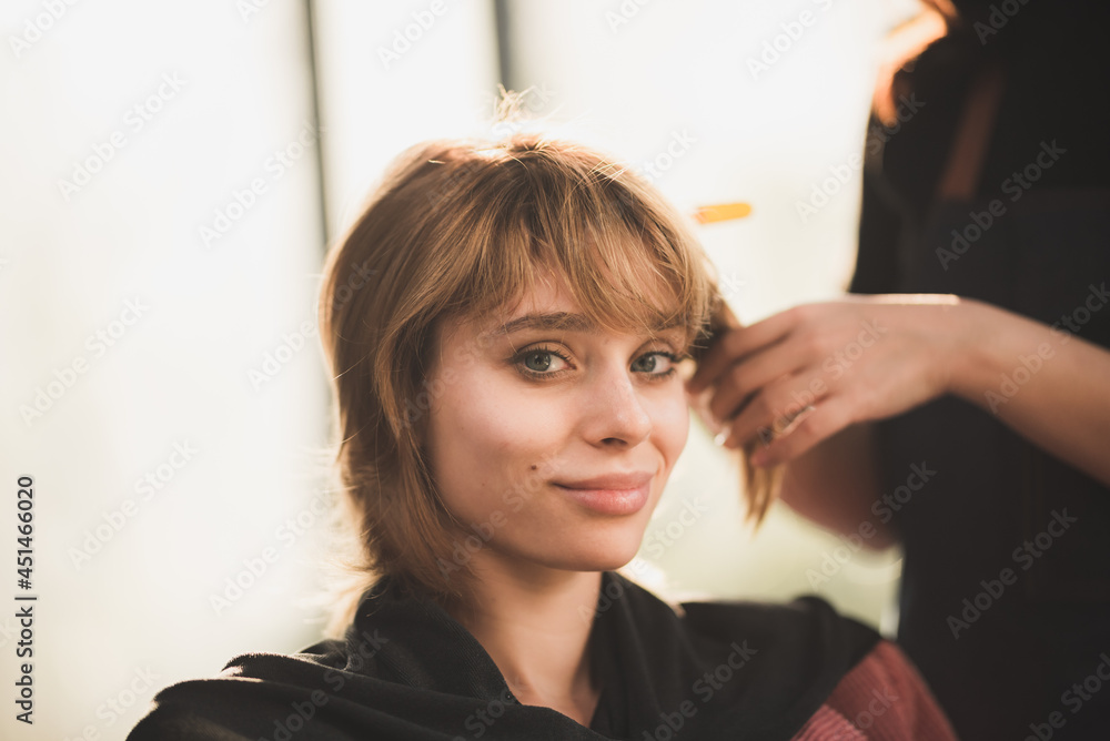 Fototapeta premium professional hairdresser stylist person and hair fashion beauty salon concept, woman client about haircut and hair care, coiffure barber equipment, hairstylist work to making hairstyle to woman model