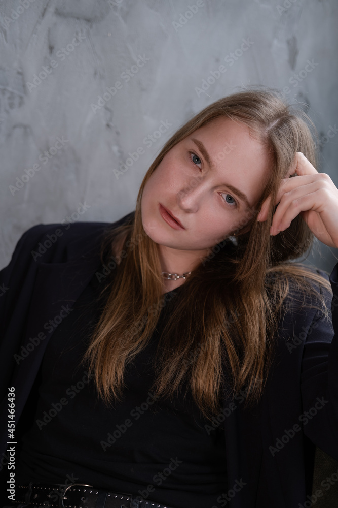 portrait of confident serious brunette woman in black clothes on dark background. femininity portrait of confident serious brunette woman in black clothes on dark background. femininity