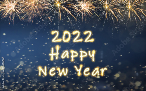 Bright text 2022 Happy New Year made of sparkler on dark background. Greeting card design