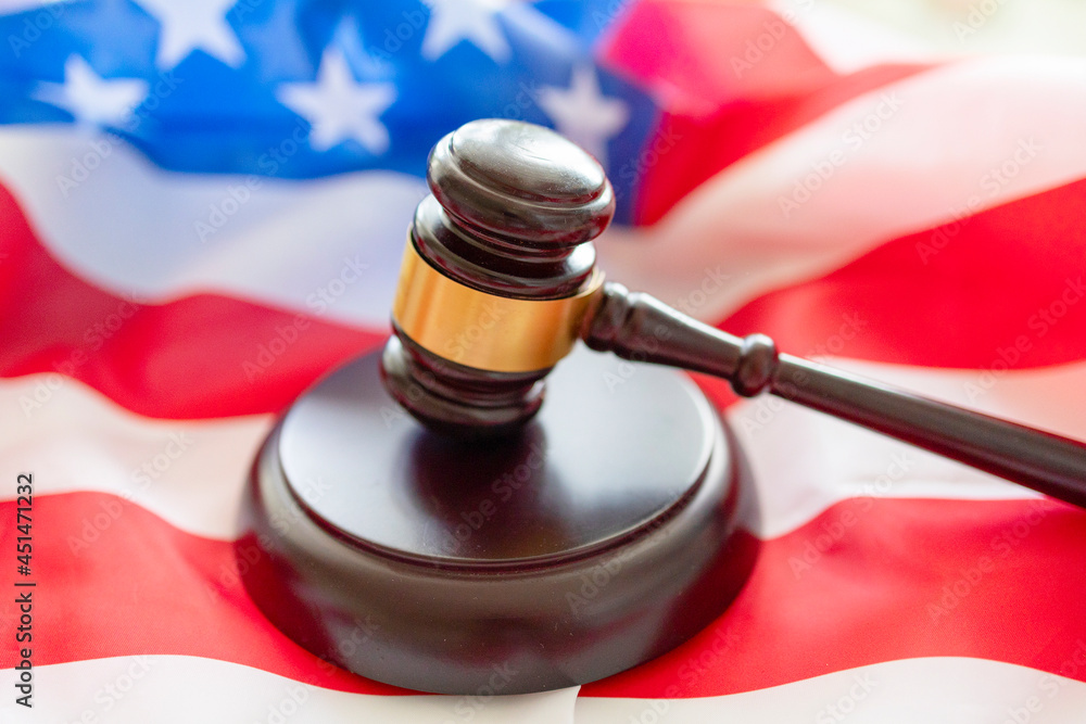 brown gavel against the background of the American flag, the concept of a fair judicial system in the United States