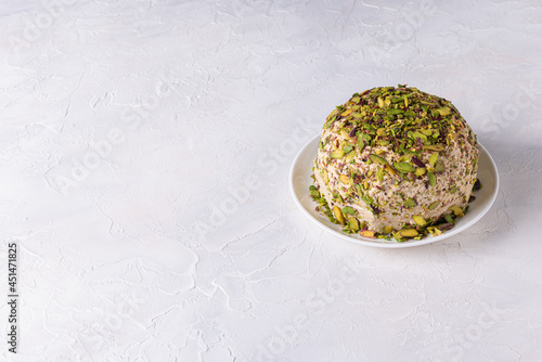 Halva with pistachios on white background with copy space