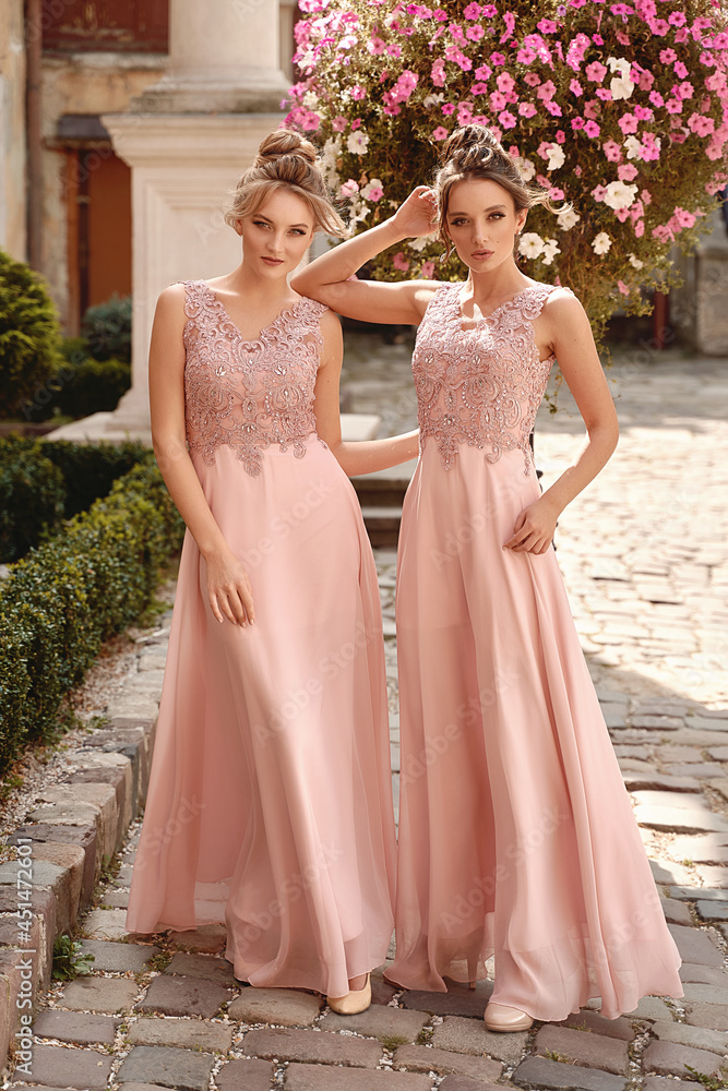 European girls bridesmaids in pink dresses having fun