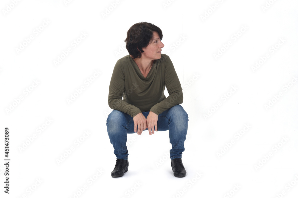 front view of a woman sitting squatting and look away on white background