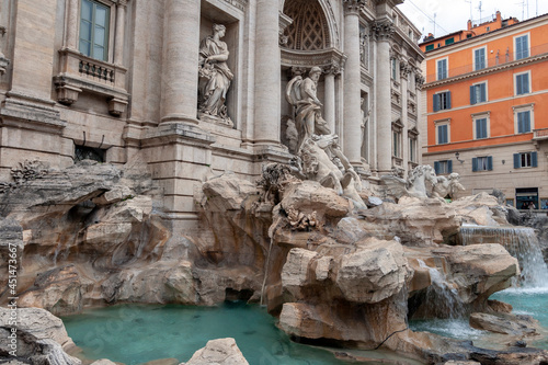 The Trevi Fountain in Rome on a cloudy summer day.