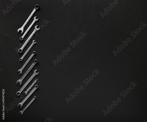 Adjustable wrench on black background