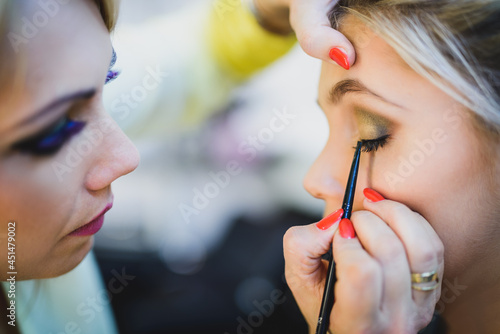 Makeup Artist Applying Eye Shadow On A Girl