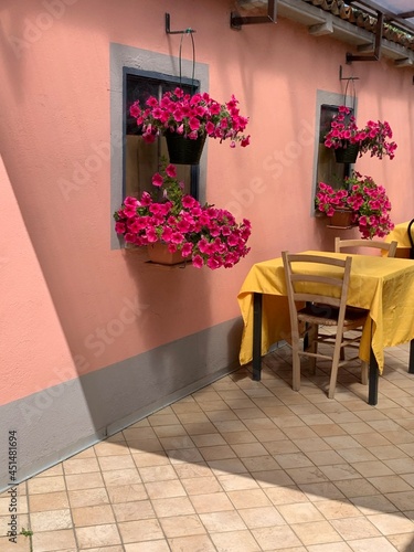 Pink wall of a countryside restaurant with a table for two