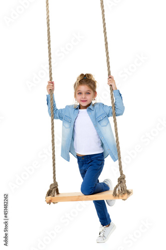 Lovely Blonde Girl Swinging on Rope Swing and Looking at Camera