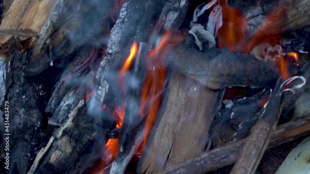 A burning bonfire on the stones. Hot fire. Firewood and sticks. Close-up. Flame and smoke. Fire for a kebab. Rest of the tourist. Waste incineration. Resting-place. A burning bonfire on the stones. Hot fire. Firewood and sticks. Close-up. Flame and smoke. Fire for a kebab. Rest of the tourist. Waste incineration. Resting-place.