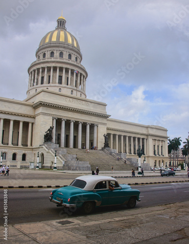 Classic auto drives past the Capitolio building, Havana, Cuba. © raquelm.