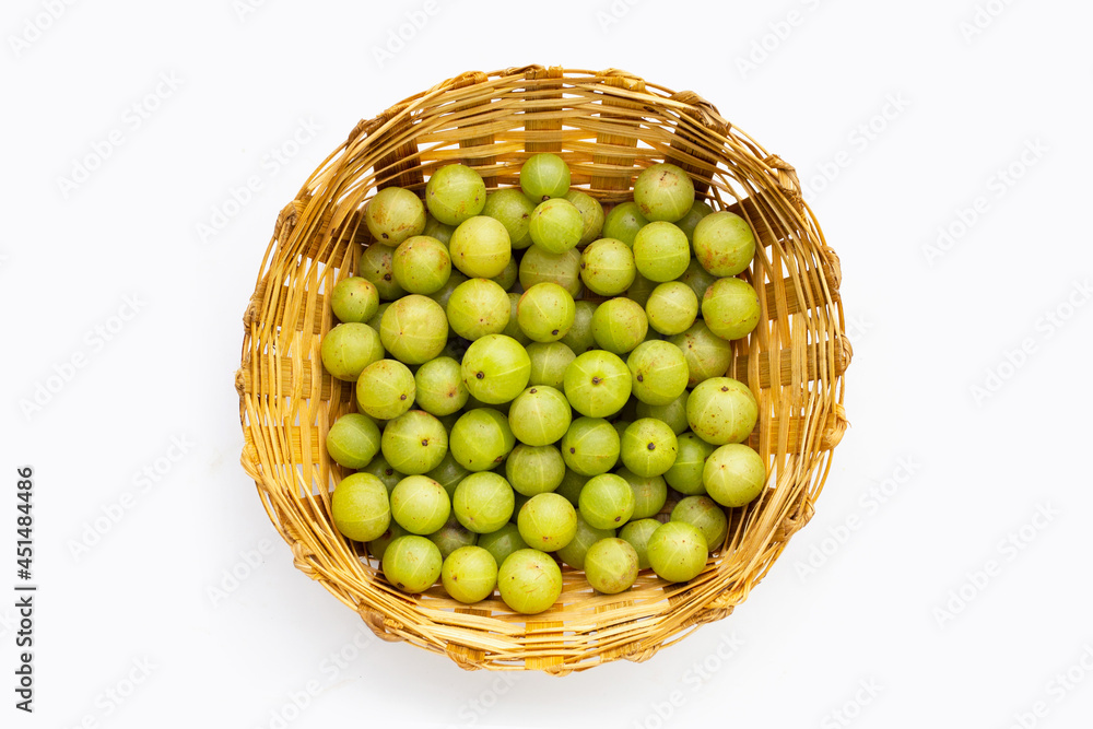 Fresh emblica in bamboo basket on white background. Fresh emblica in bamboo basket on white background.