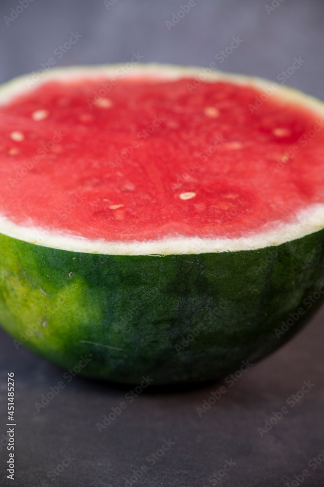 half ripe watermelon on a dark background half ripe watermelon on a dark background