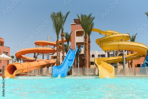 Colorful aquapark constructions in swimming-pool