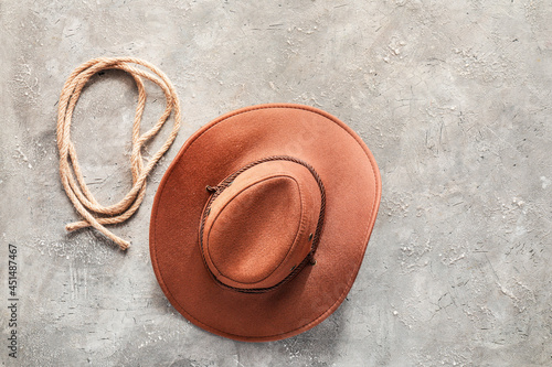 Cowboy hat and lasso on grunge background