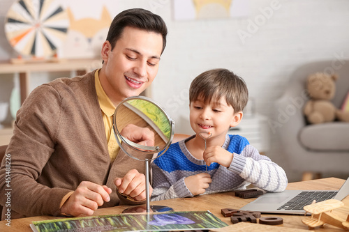 Speech therapist working with little boy in office