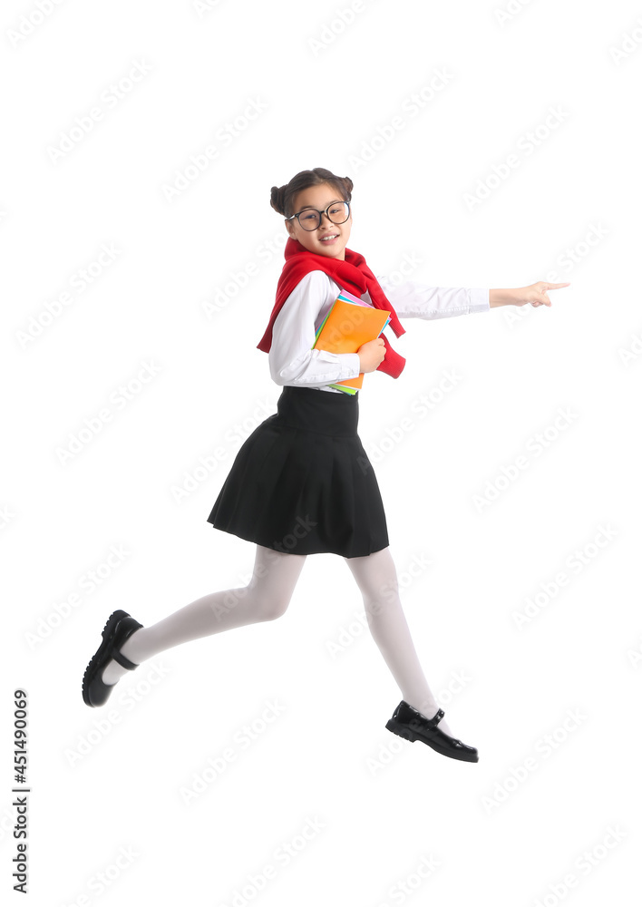 Jumping little schoolgirl with notebooks on white background