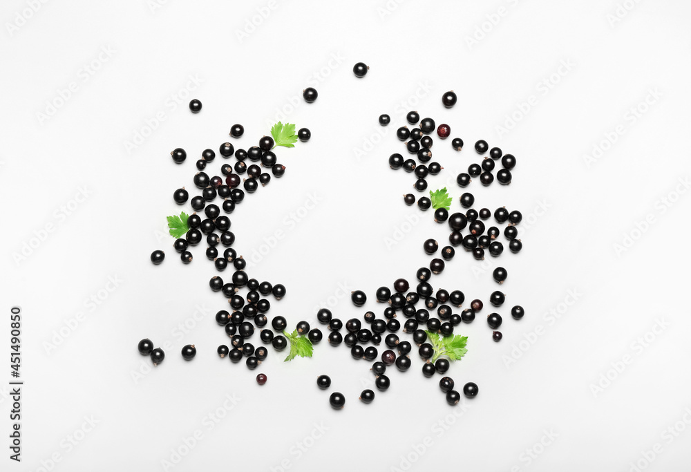 Frame made of ripe black currant on light background Frame made of ripe black currant on light background