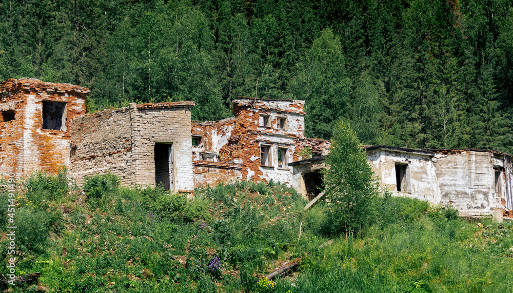 ruins of an old brick industrial building among the forest in the mountains