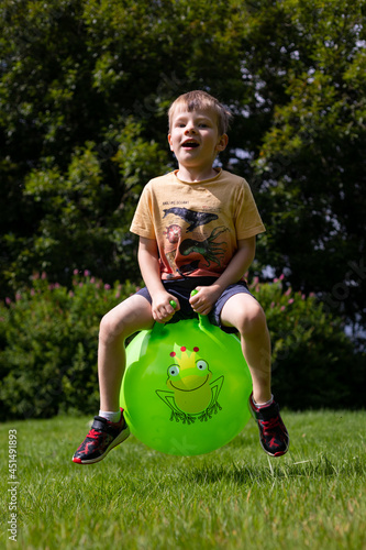 Boy bouncing on a space hopper
