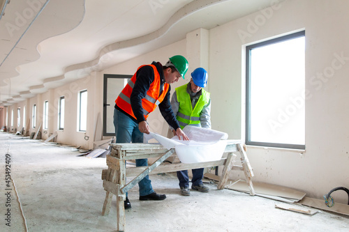 Teamwork on construction site with two engineers.