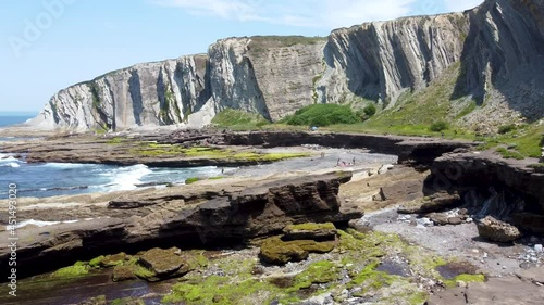 Aerial flight with drone over the Basque coast. Rocky cove between ravines