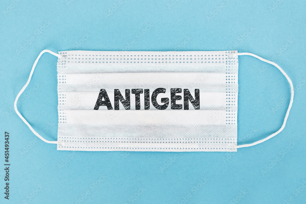 Medical face mask with ANTIGEN text on blue background. Medical face mask with ANTIGEN text on blue background.