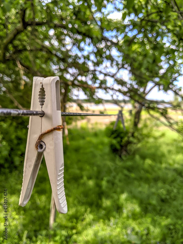Wooden clothespins are hanging on a rope. The beauty of simple wooden clothespins. Environmentally friendly materials.