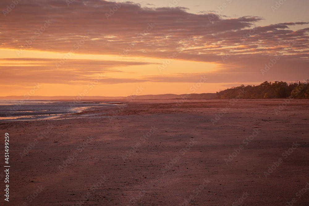 Sunrise over the horizon over the sea at the beach in Darwin, Northern Territory, Australia