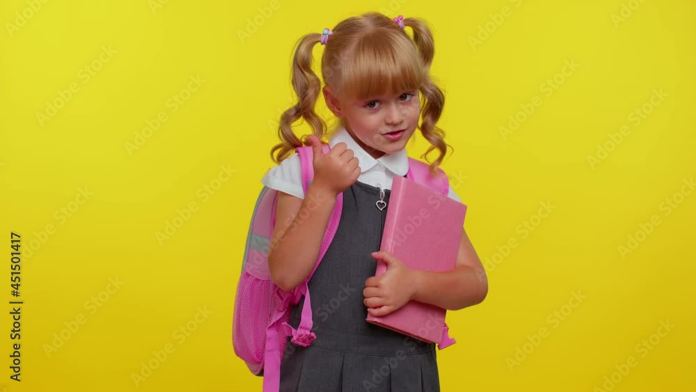 I am the best. Happy satisfied selfish haughty kid school girl proud of her victory, bragging own success win achievements, pointing with smile fingers on herself on yellow background. Back to school I am the best. Happy satisfied selfish haughty kid school girl proud of her victory, bragging own success win achievements, pointing with smile fingers on herself on yellow background. Back to school