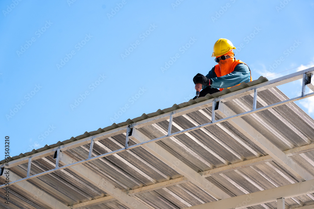Roofing,Construction workers wearing safety harness checking and installation assembly of new roof,Roofing tools.