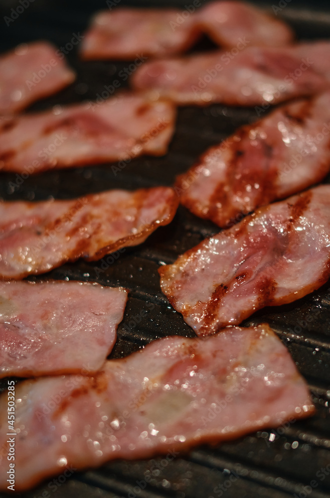Close up of grilled bacon on the frying pan Close up of grilled bacon on the frying pan
