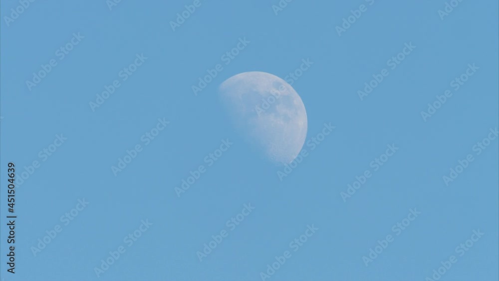 Flying kite against blue sky and big half moon in summer afternoon like landing on moon, childhood freedom toy relax concept, 4k real time footage. Flying kite against blue sky and big half moon in summer afternoon like landing on moon, childhood freedom toy relax concept, 4k real time footage.