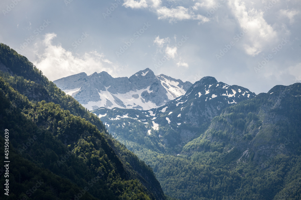 Fototapeta premium Triglav, Mali Draski, Tosc and Skrlatica mounts in the Julian Alps, in Slovenia, by Bohinj, during a cloudy afternoon in summer. Triglav vrh is the highest peak and mountain of Slovenia. ..