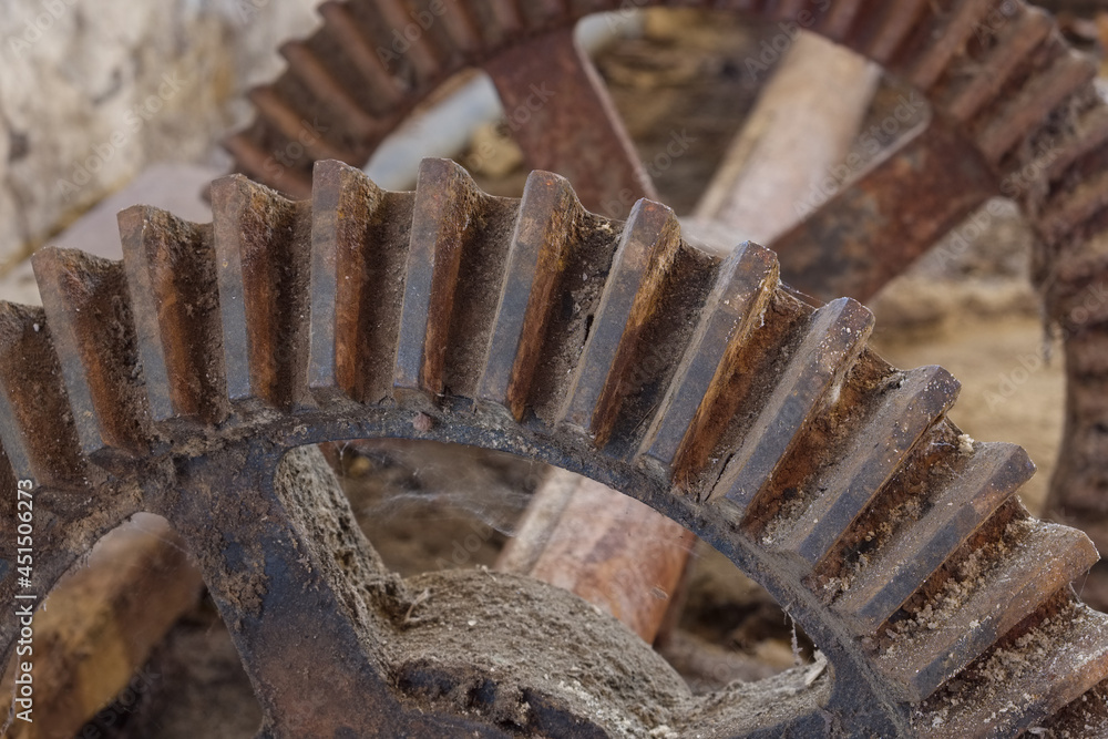Metal teeth and cogs on an old shaft and steel wheel