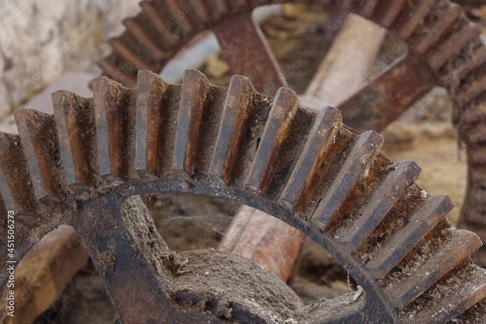 Metal teeth and cogs on an old shaft and steel wheel Metal teeth and cogs on an old shaft and steel wheel