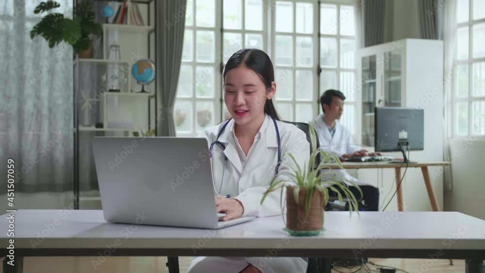 Young Asian Woman Doctor Is Using Laptop In Workplace. Medical Concept
Young Asian Woman Doctor Is Using Laptop In Workplace. Medical Concept
