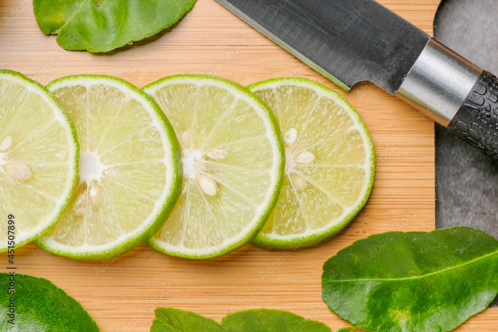 limes slices on wooden with leave, Top view limes slices on wooden with leave, Top view