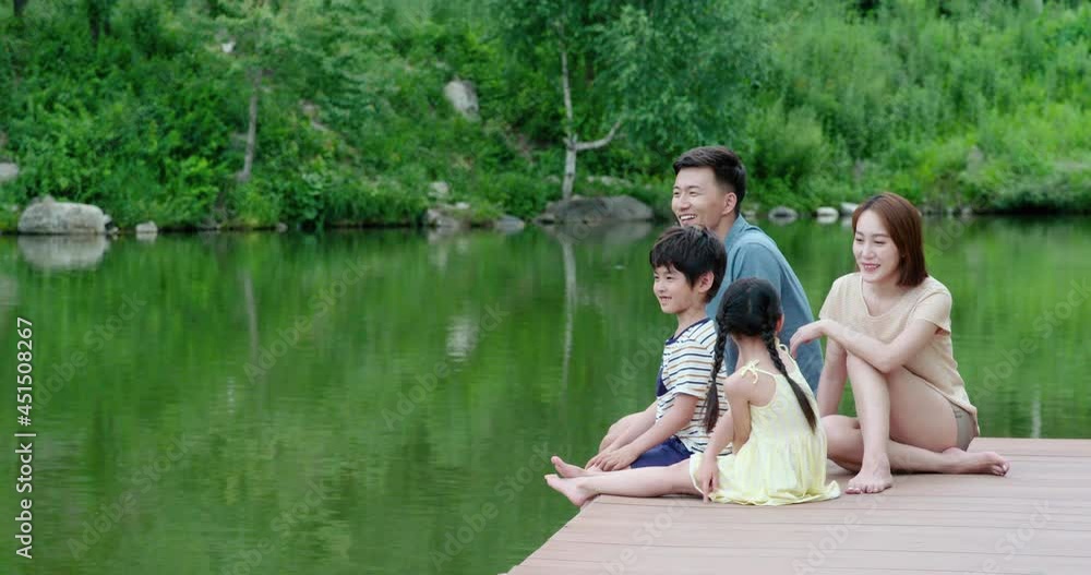 Happy young Chinese family relaxing by the river,4K Happy young Chinese family relaxing by the river,4K