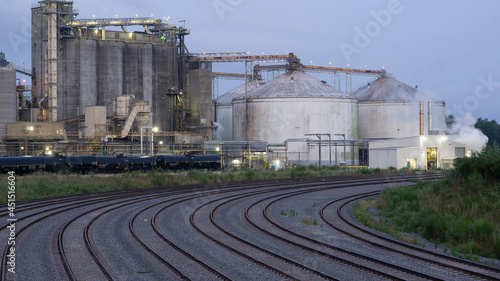 Closeup shot of railroads and industrial buildin photo