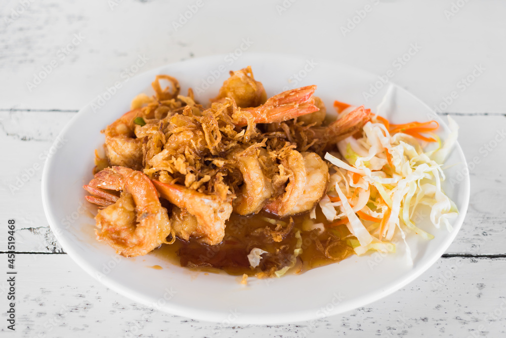 Delicious thai food, deep fried prawns in tamarind sauce on wooden table. Delicious thai food, deep fried prawns in tamarind sauce on wooden table.
