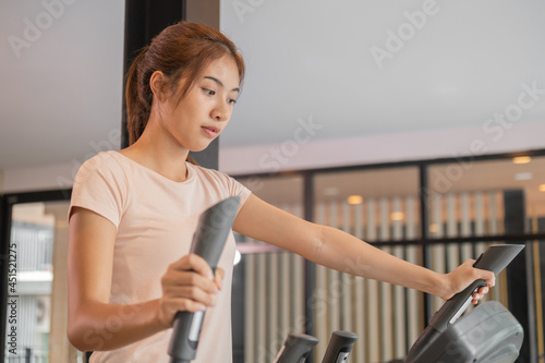 Workout woman, girl, exercise on elliptical cross trainer in fit sportswear, practice working out training for health. Sport strong person in gym fitness for healthy lifestyle, recreation concept.