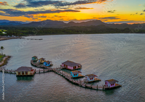 Cottages and docks on the sea during the sunset in Maimon Bay, Puerto Plata, the Dominican Republic