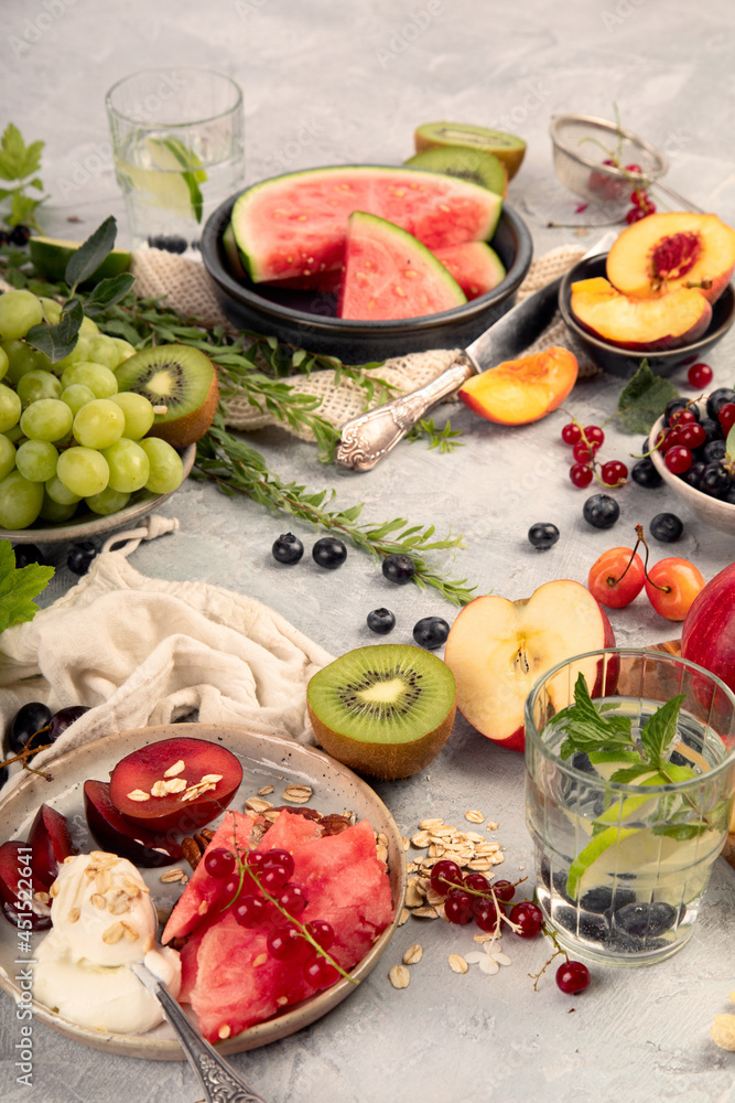 Fruit assortment served on light gray table.