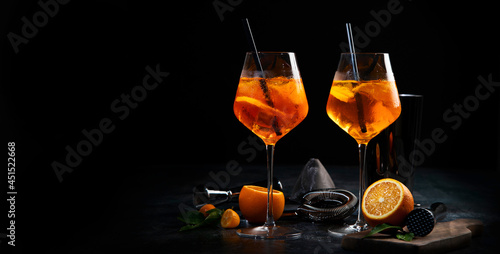Aperol spritz cocktail served on dark background.