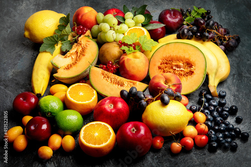 Fototapeta Naklejka Na Ścianę i Meble -  Assorted fresh fruits on dark background.