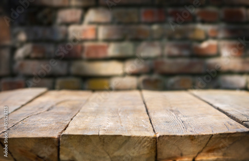 Old vintage empty table on brick wall background with sunbeams