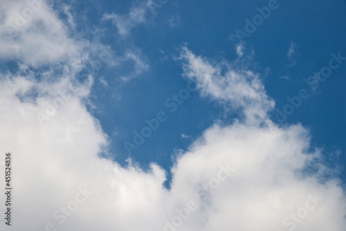 White clouds on the blue sky perfect for the background. Clear blue sky and white clouds. Blue sky background with clouds.