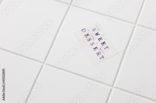 sticker with sweet dessert on white tile background