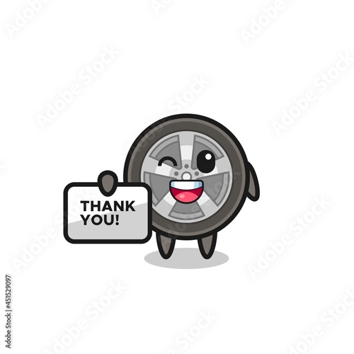 the mascot of the car wheel holding a banner that says thank you